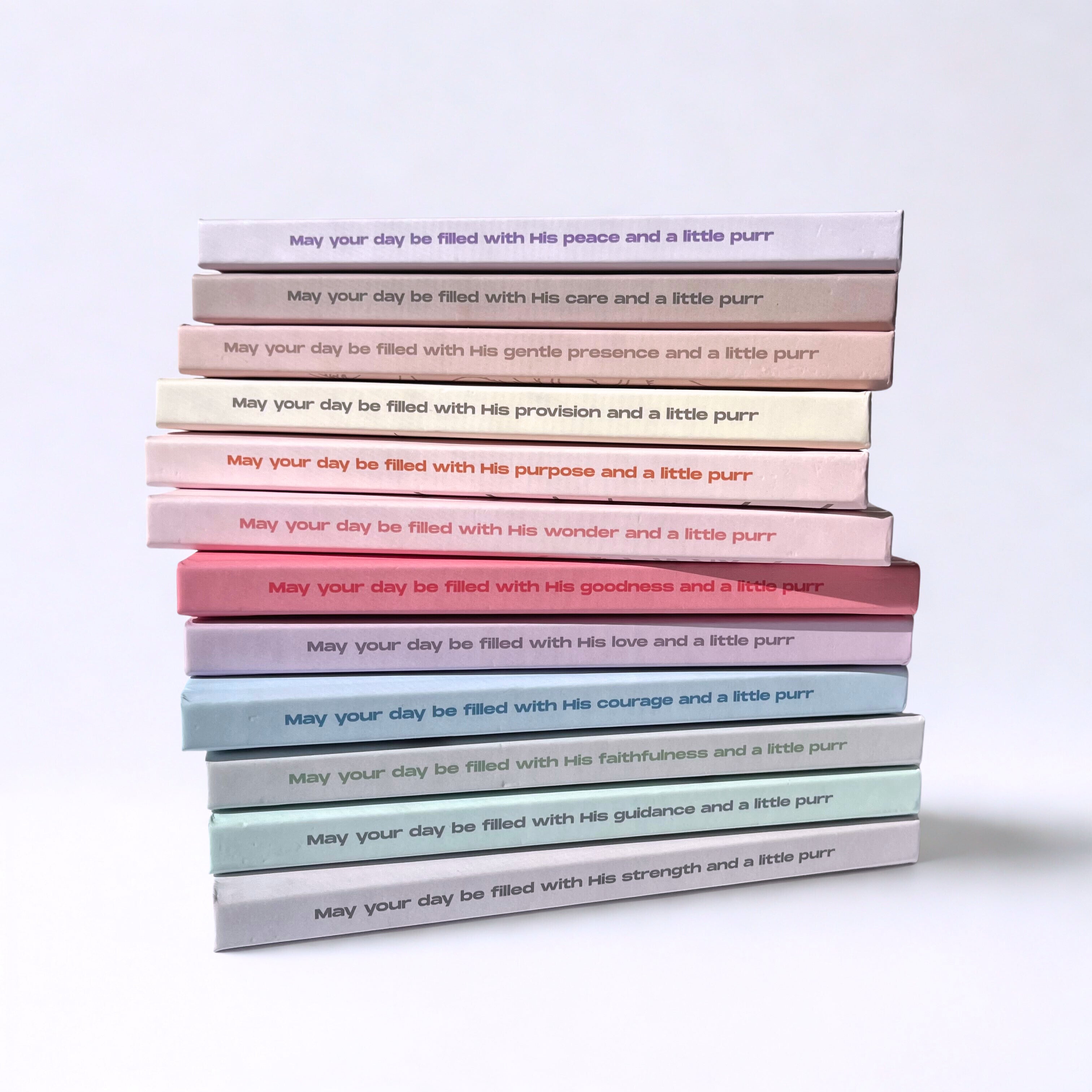 Stack of christian cat notebooks laying on the table.