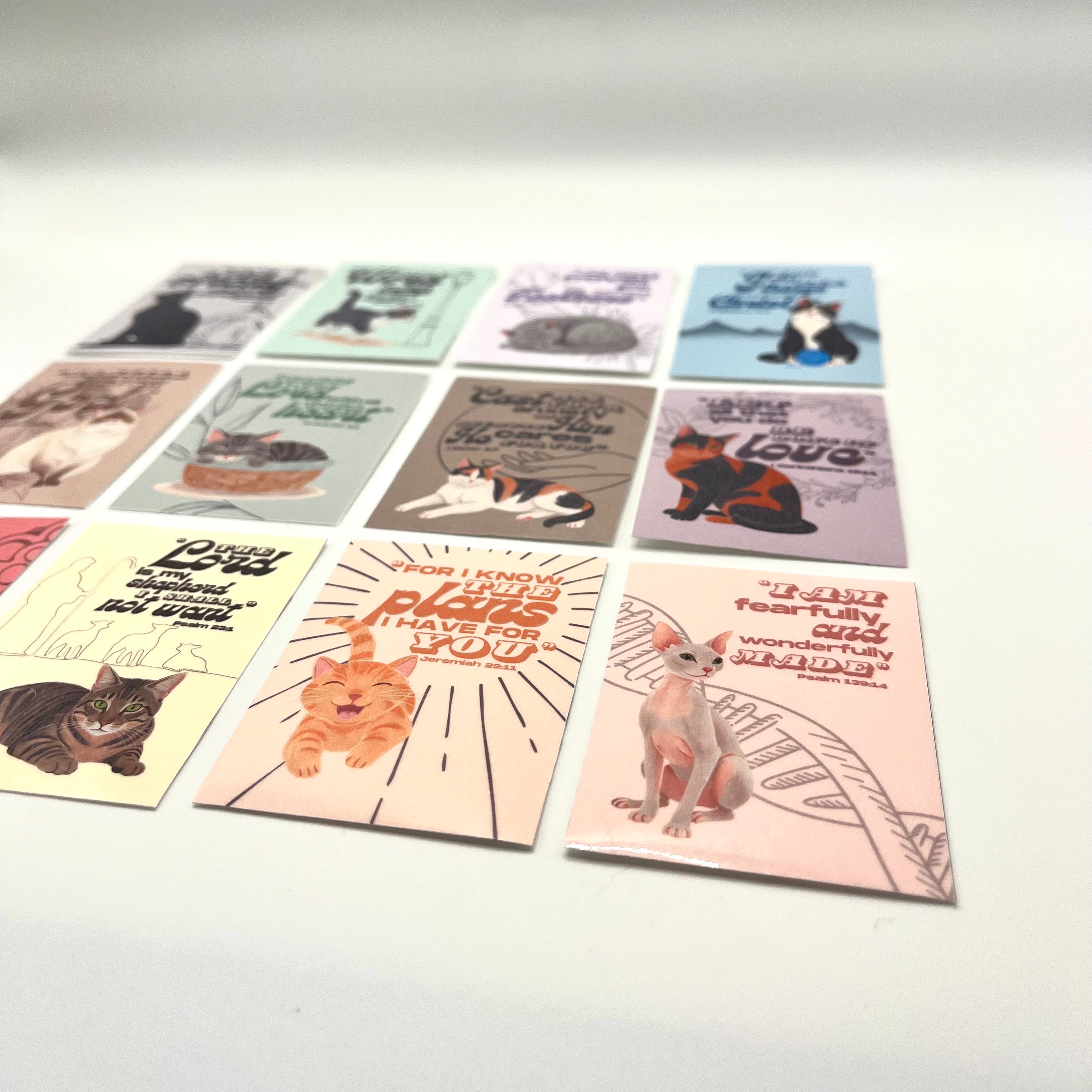 Angled top-down image showing the 12-pack cute cat stickers with clear detail of each sticker design.