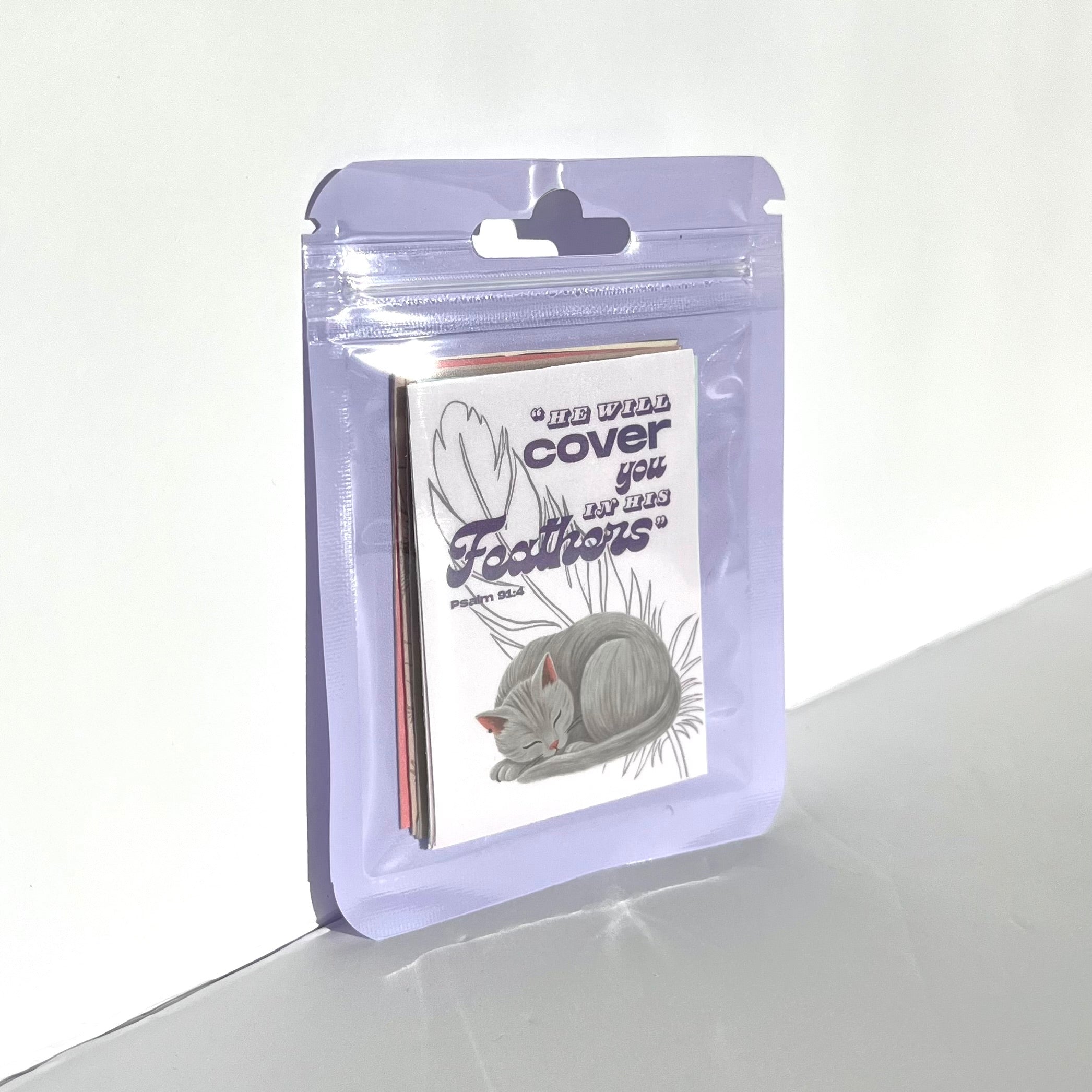 12-pack cute cat stickers packaged in a clear plastic bag, shown for size and packaging detail.