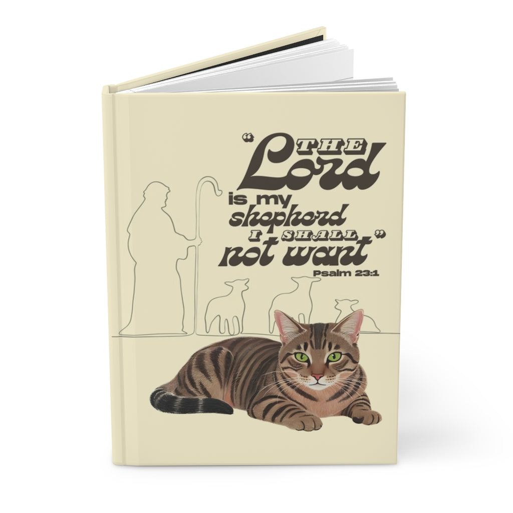 Notebook with a cat illustration and religious text on a beige background