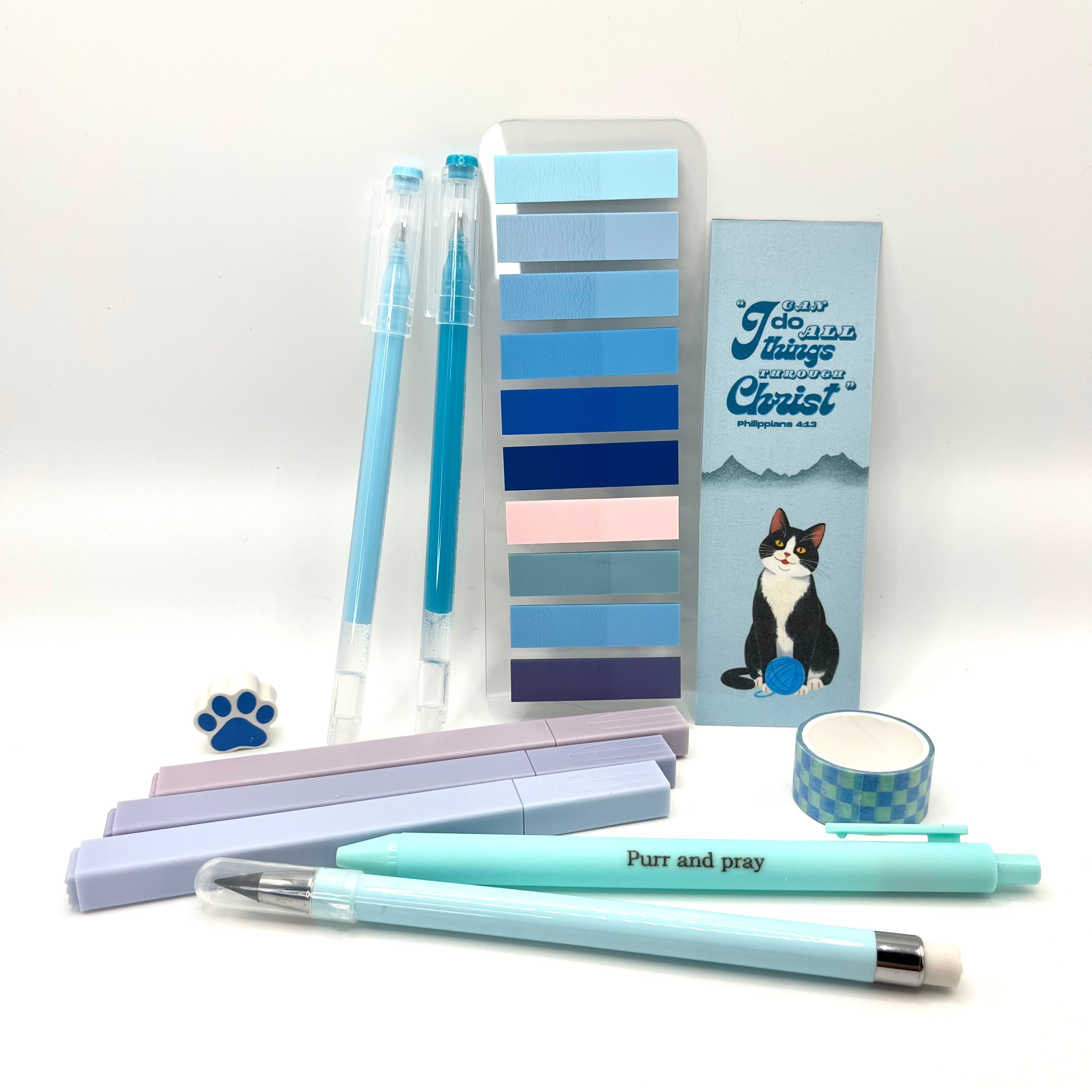 Christian stationery set including highlighters, gel pens, everlasting pencil, sticky notes, washi tape, bookmark, and eraser arranged neatly in blue color palette.