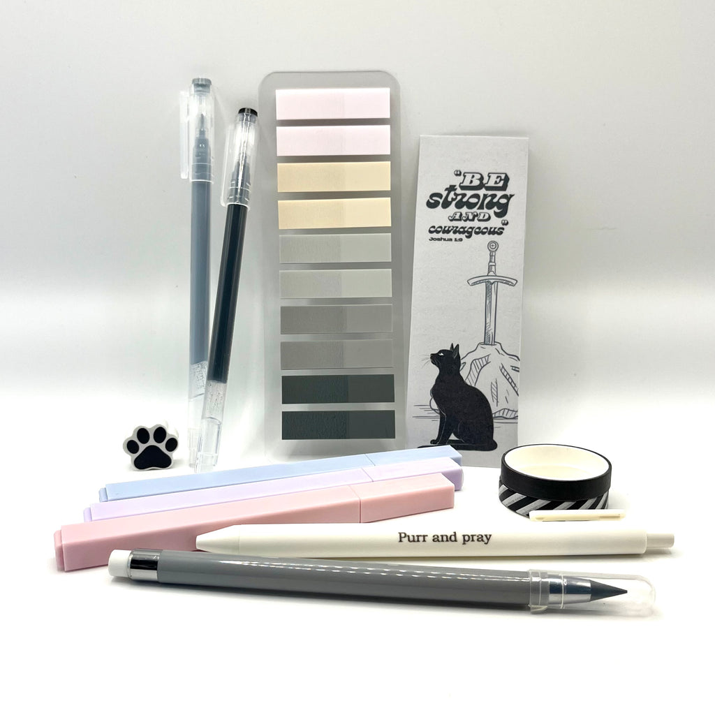 Christian stationery set including highlighters, gel pens, everlasting pencil, sticky notes, washi tape, bookmark, and eraser arranged neatly in gray color palette.
