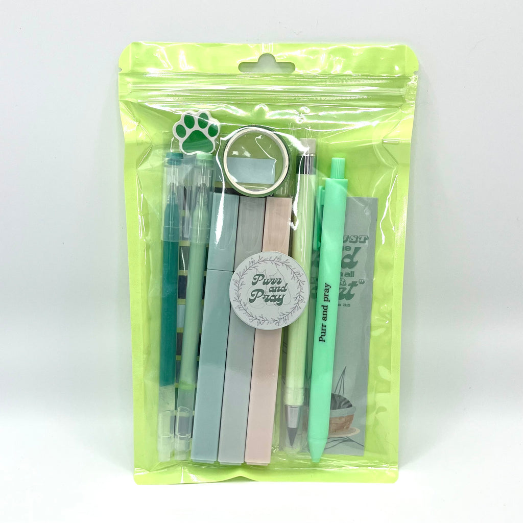Stationery set packaged in a clear bag including pens, highlighters, sticky notes, washi tape, bookmark, and eraser for Christian journaling arranged neatly in green color palette.