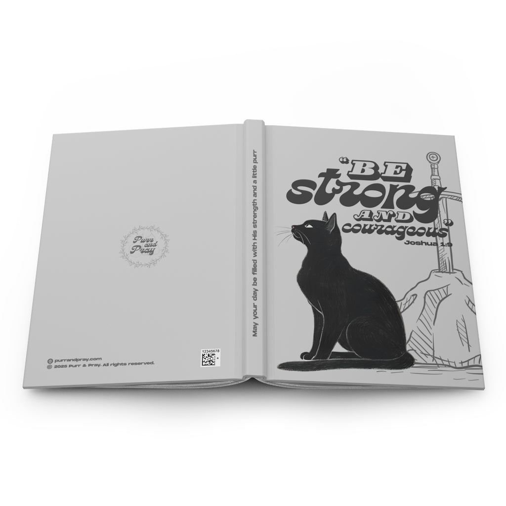 Open book with a black cat illustration and motivational text on a white background.