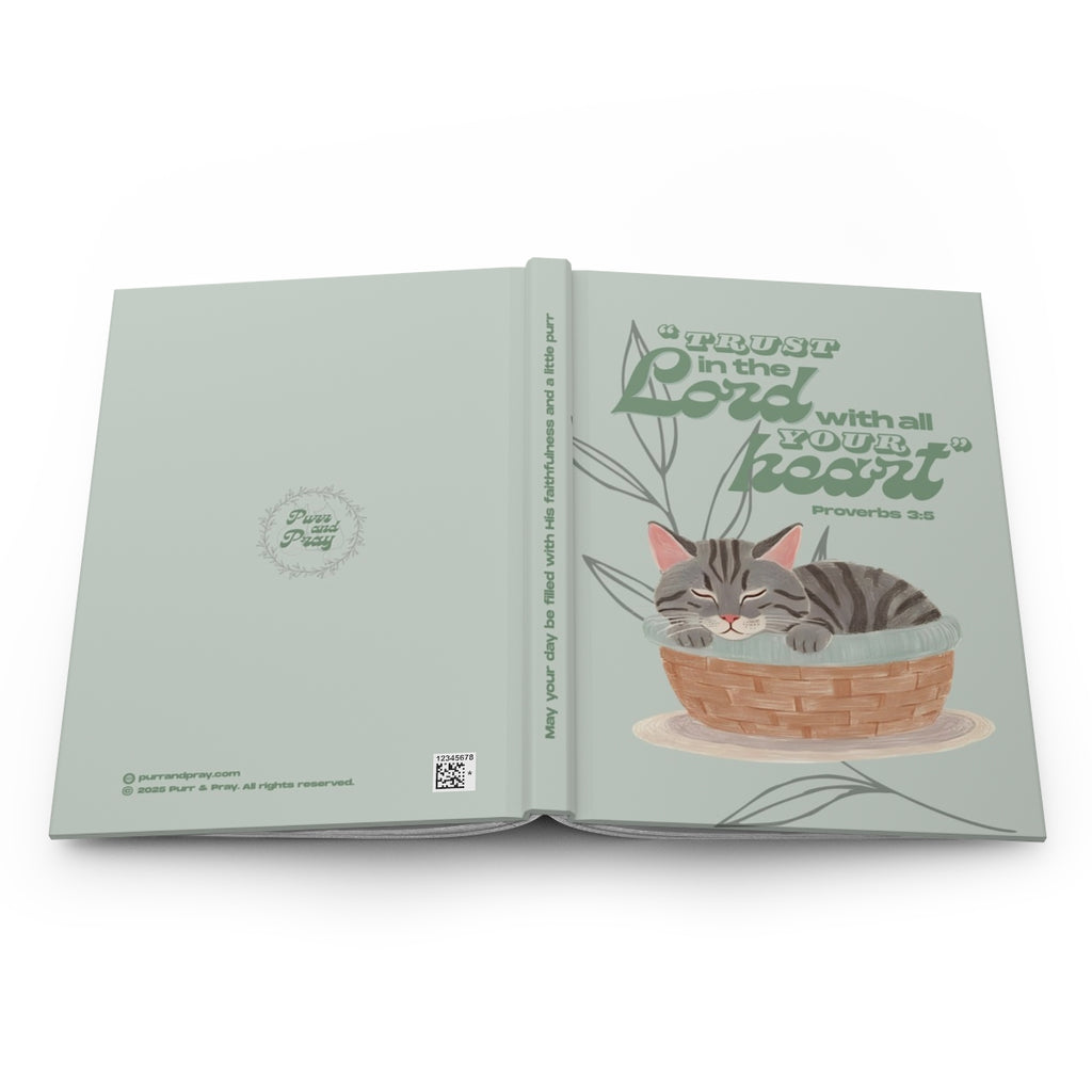 Open book with a gray tabby cat illustration and motivational text on a white background.