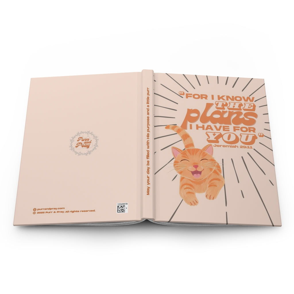 Open book with a orange tabby cat illustration and motivational text on a white background.
