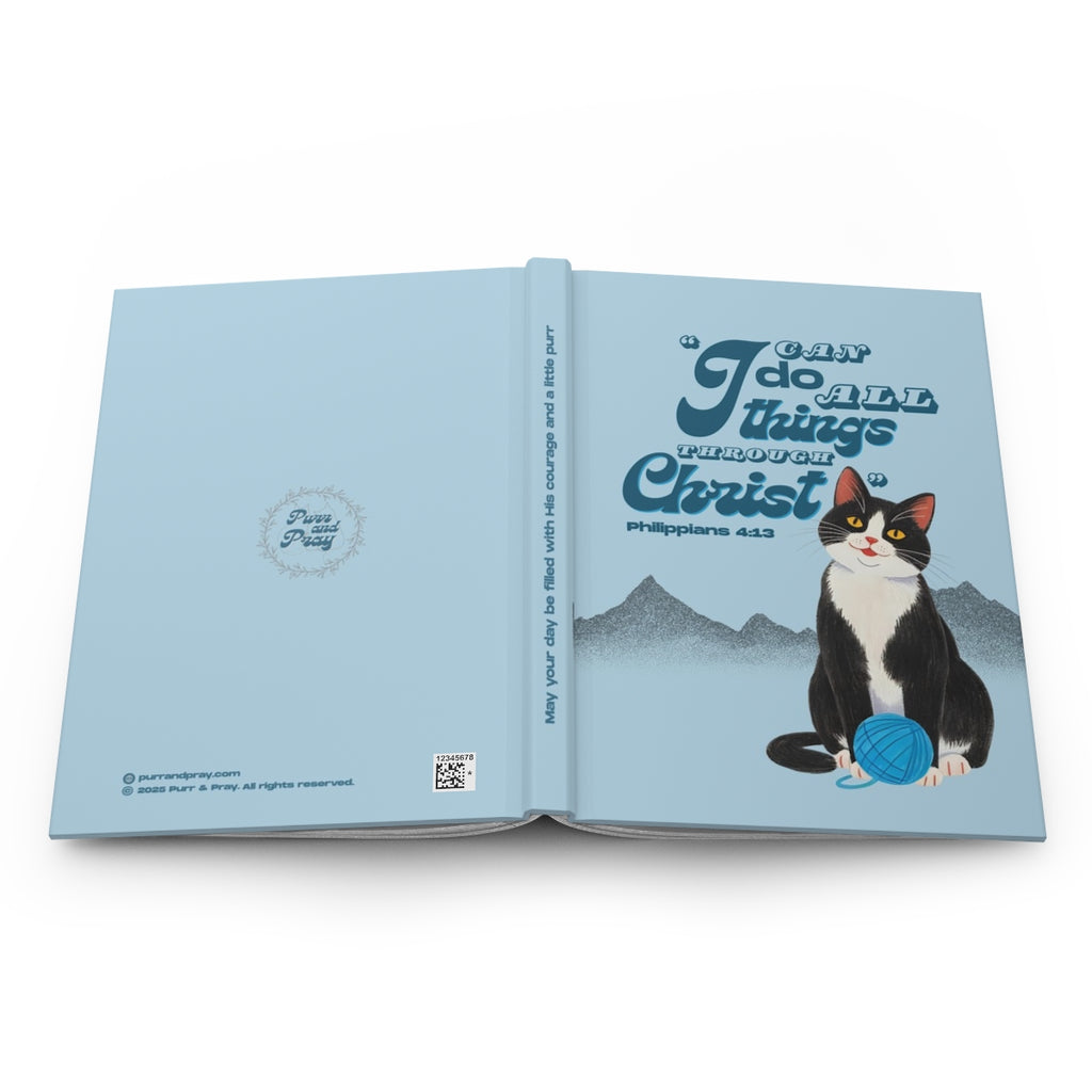 Open book with a tuxedo cat illustration and motivational text on a white background.