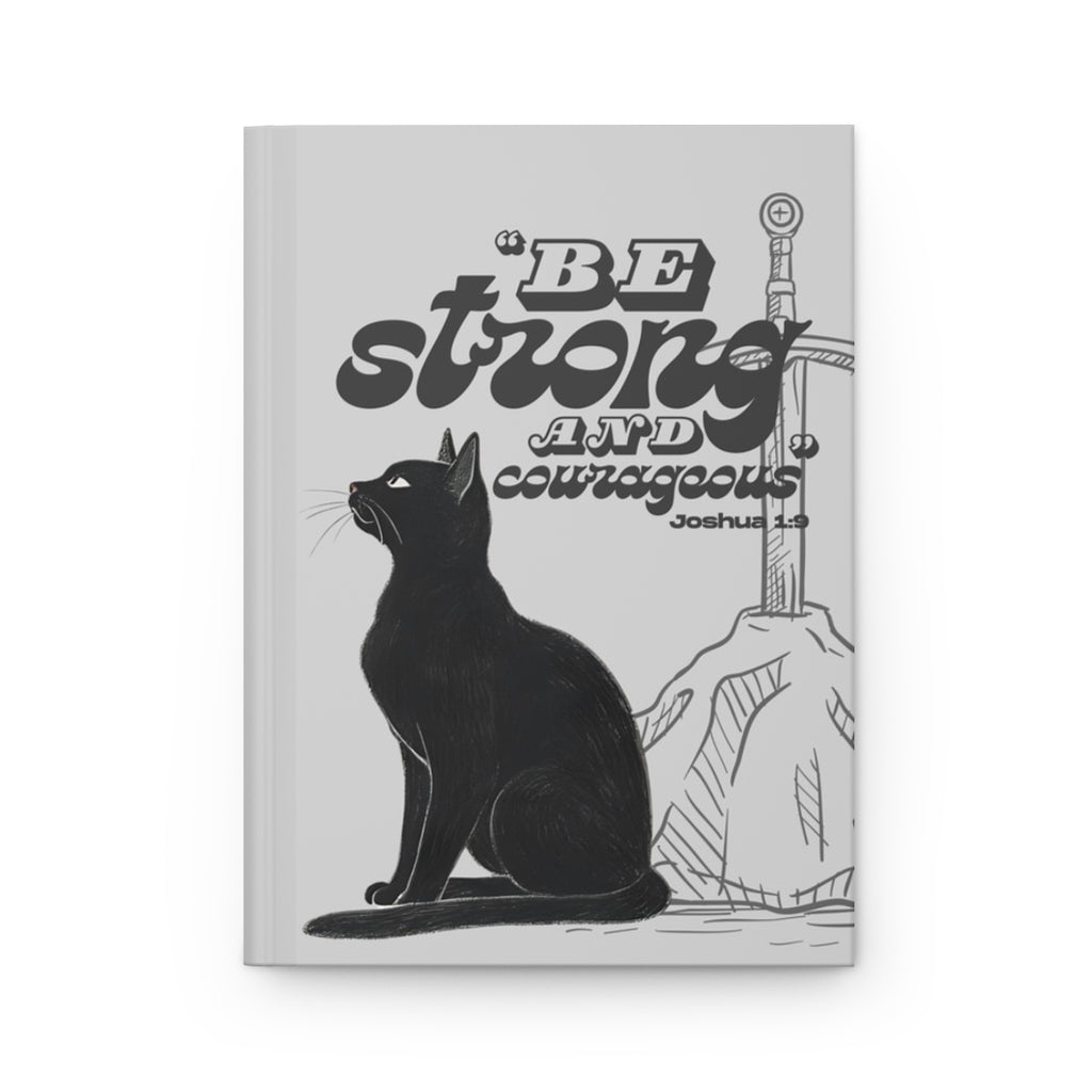Front cover of A5 Christian journal featuring the Bible verse ‘Be strong and courageous’ with a black cat illustration.