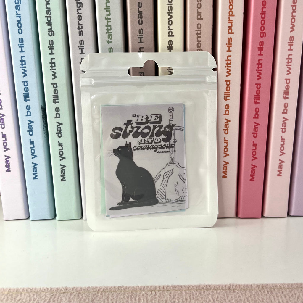 Packaged product with a cat design on a white surface with books in the background