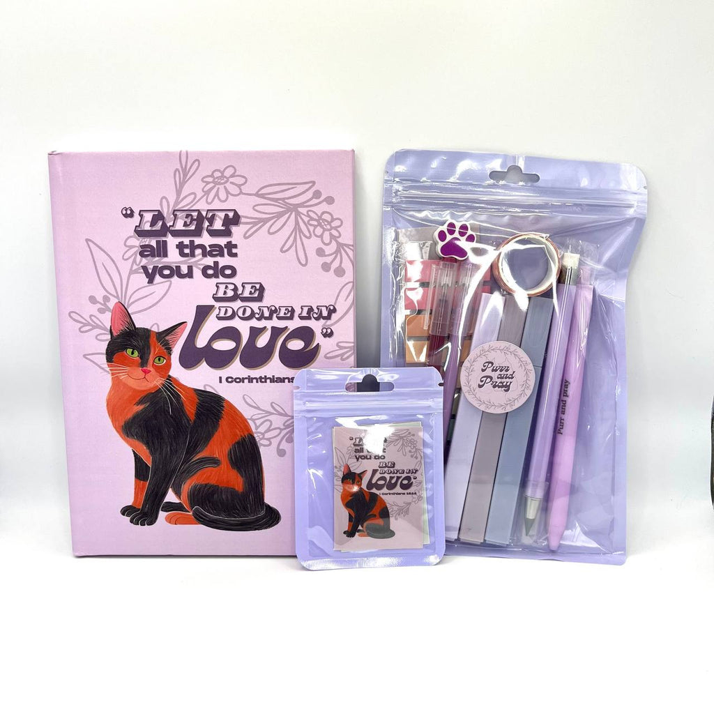 Packaged Christian gift set including a Bible verse journal with tortoiseshell cat artwork, stationery items in clear bags, and Scripture sticker pack.