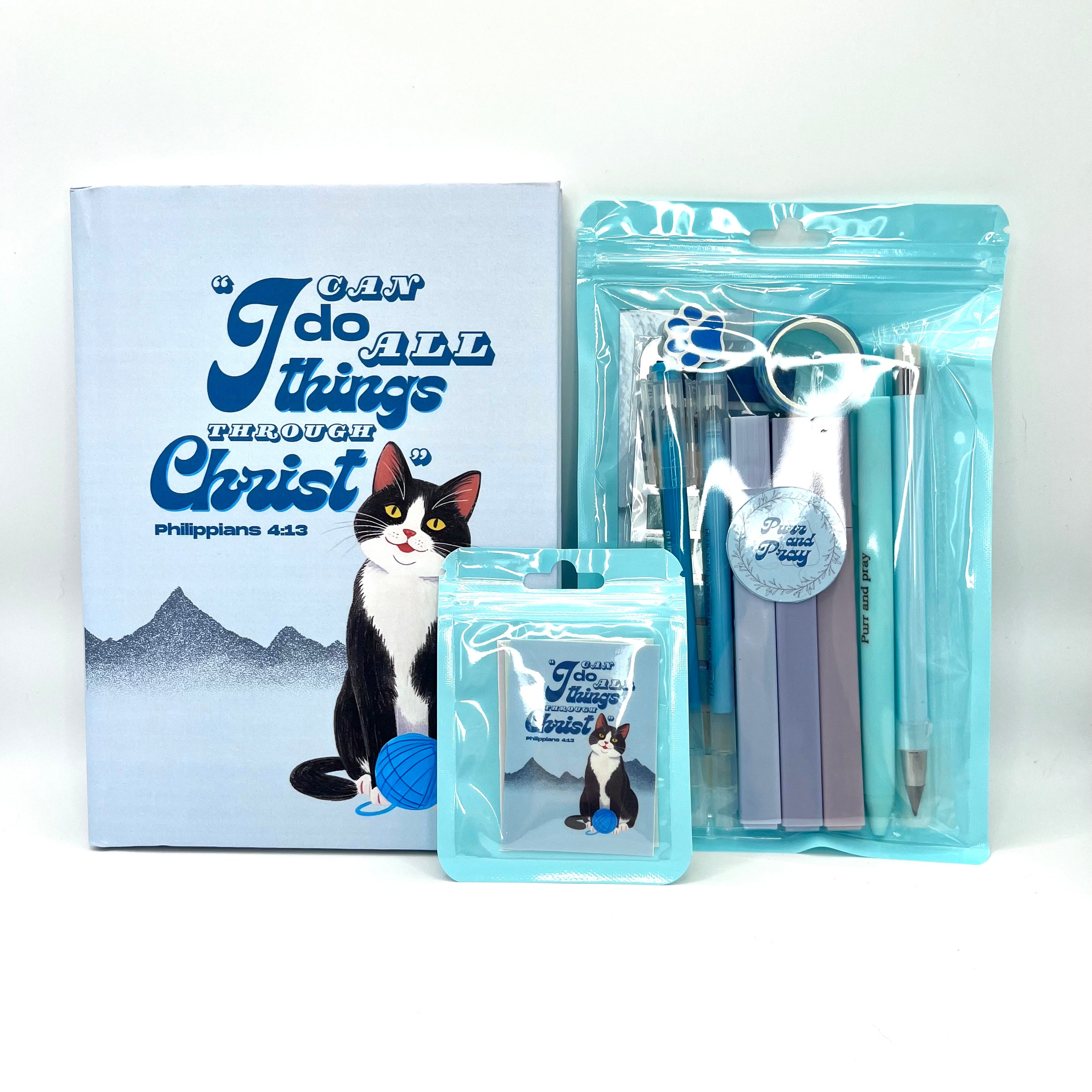 Packaged Christian gift set including a Bible verse journal with a tuxedo cat artwork, stationery items in clear bags, and Scripture sticker pack.