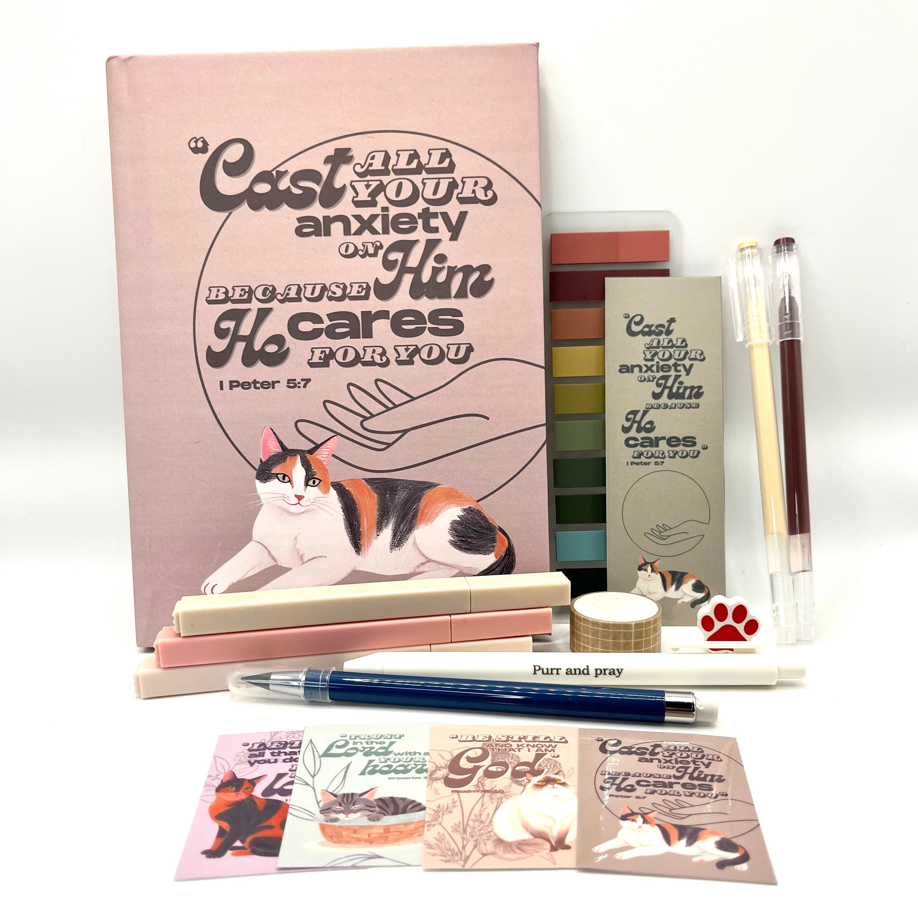 Christian journal gift set with Bible verse journal featuring a calico cat illustration, coordinated stationery items, and Scripture stickers.