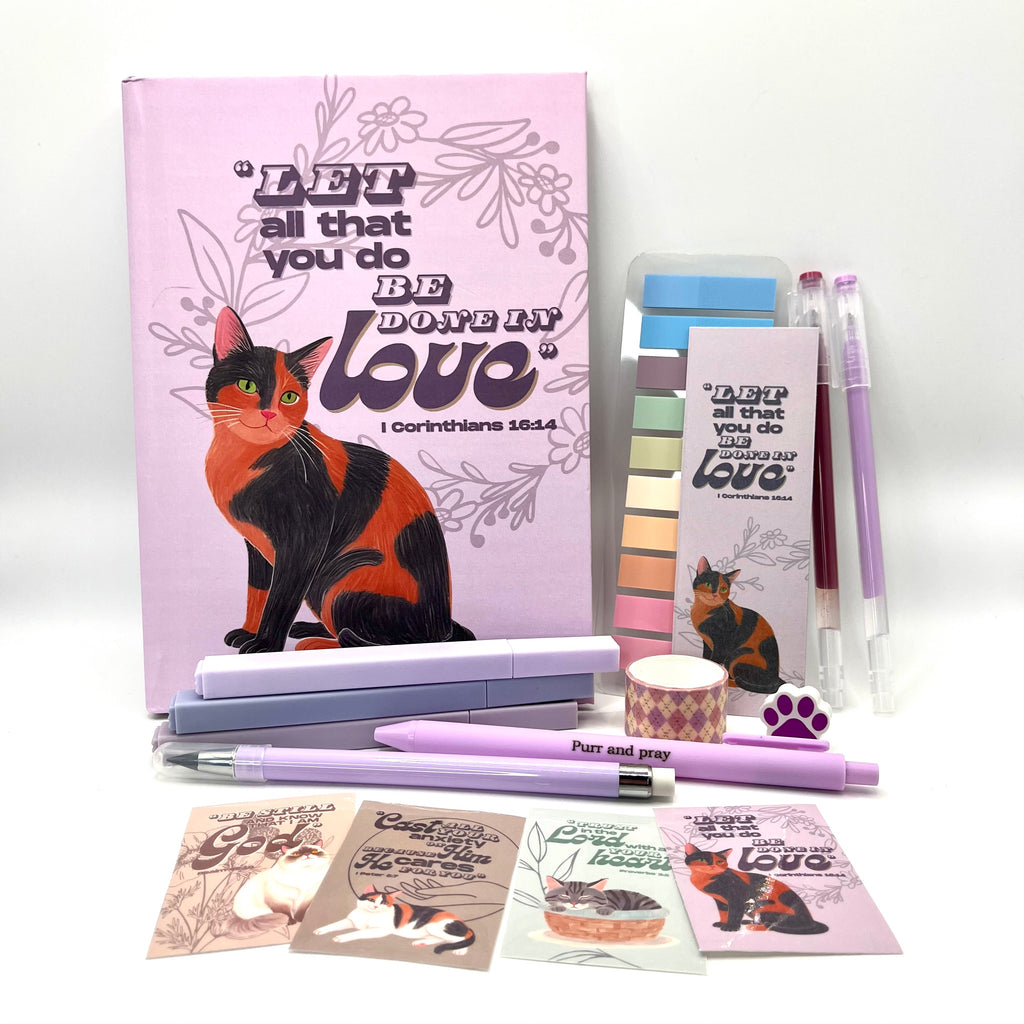 Christian journal gift set with Bible verse journal featuring a tortoiseshell cat illustration, coordinated stationery items, and Scripture stickers.