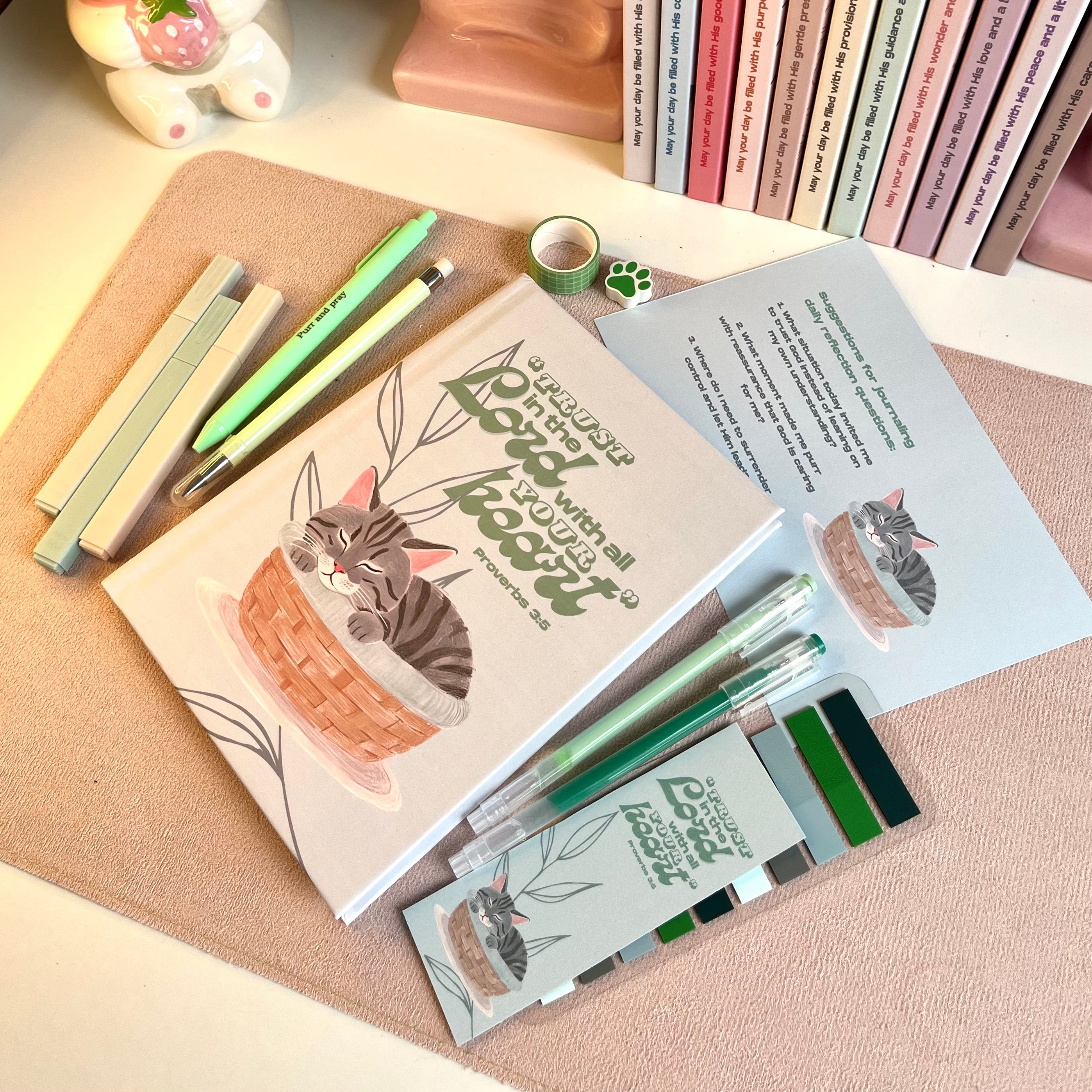 Stationery set with cat-themed items on a textured surface