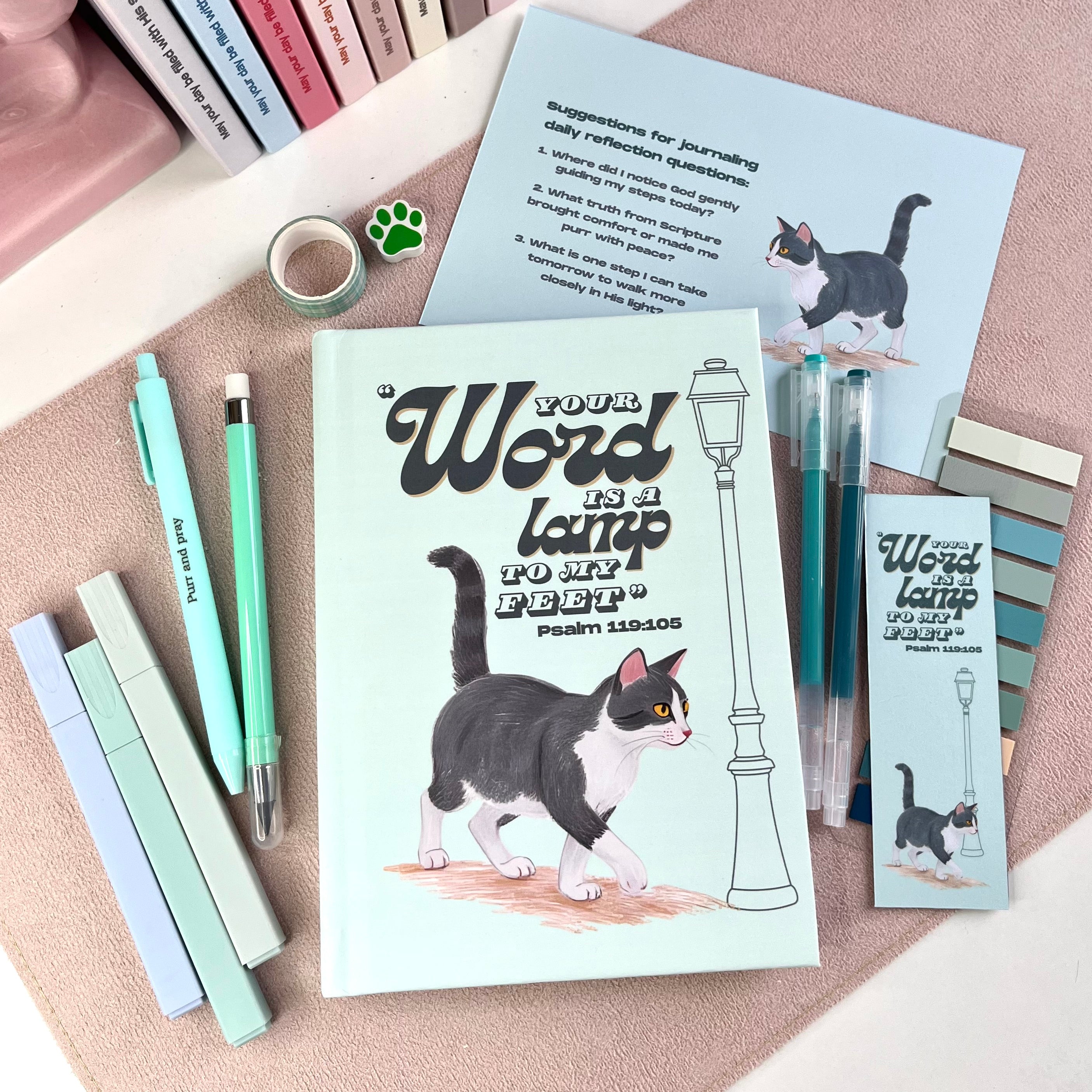 Cat-themed bookmarks and stationery items on a textured surface