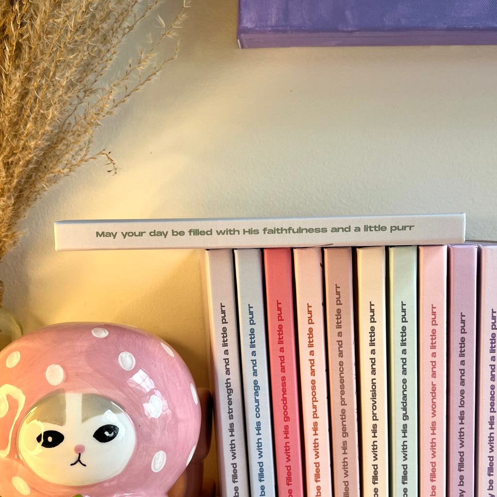 A side of a green notebook with a christian text on it.