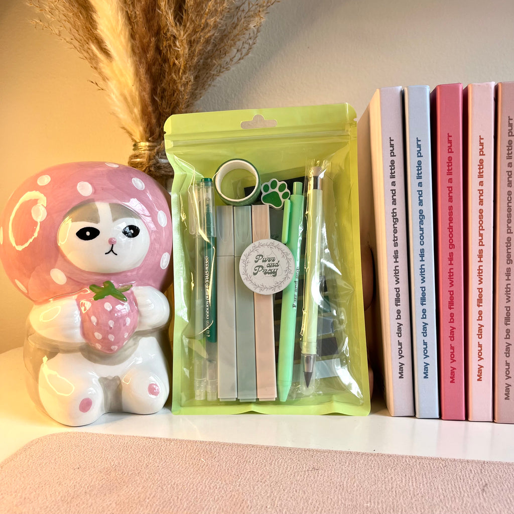 Green packaged stationery items with a gray tabby cat illustration.