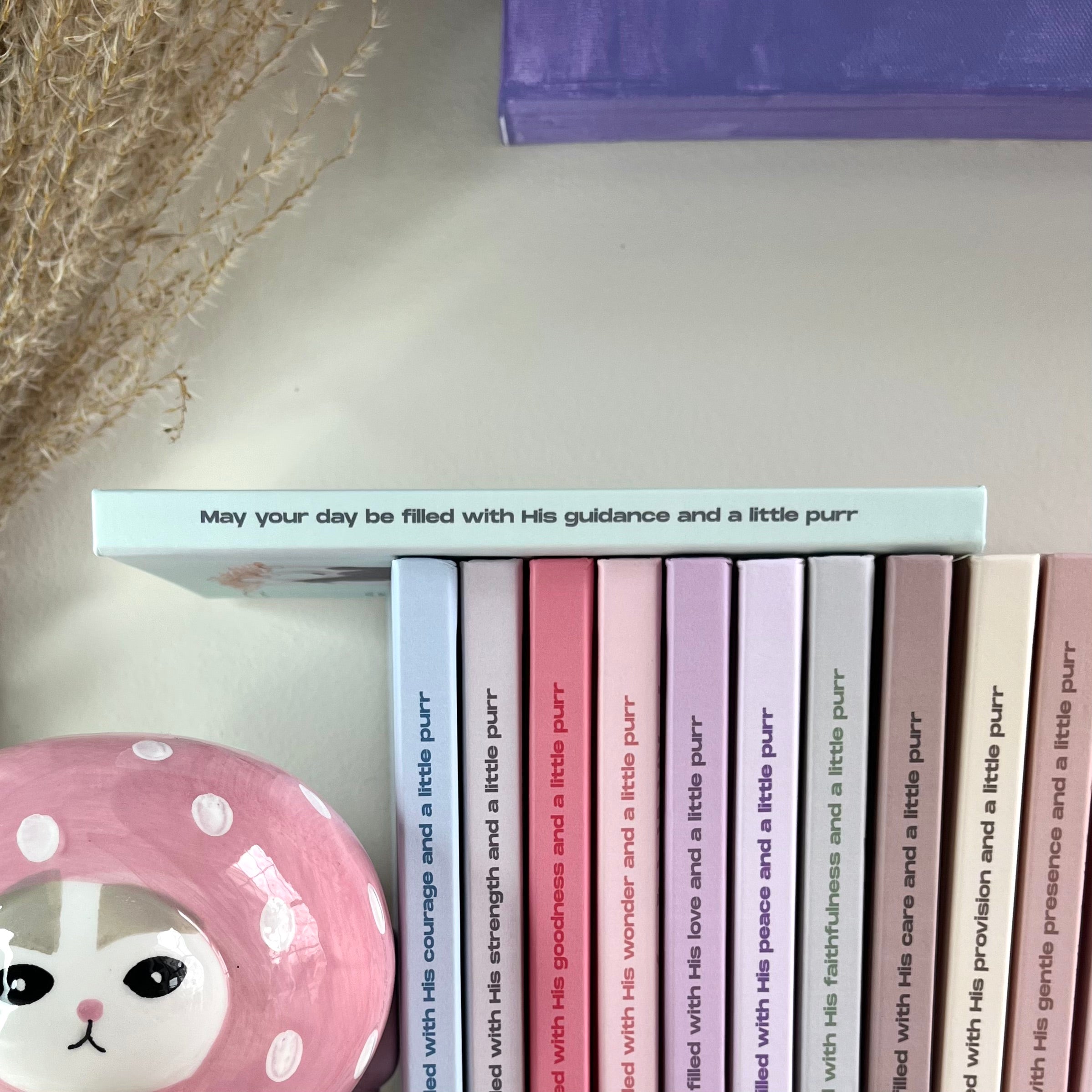 Side of a mint color notebook with a christian text on it.