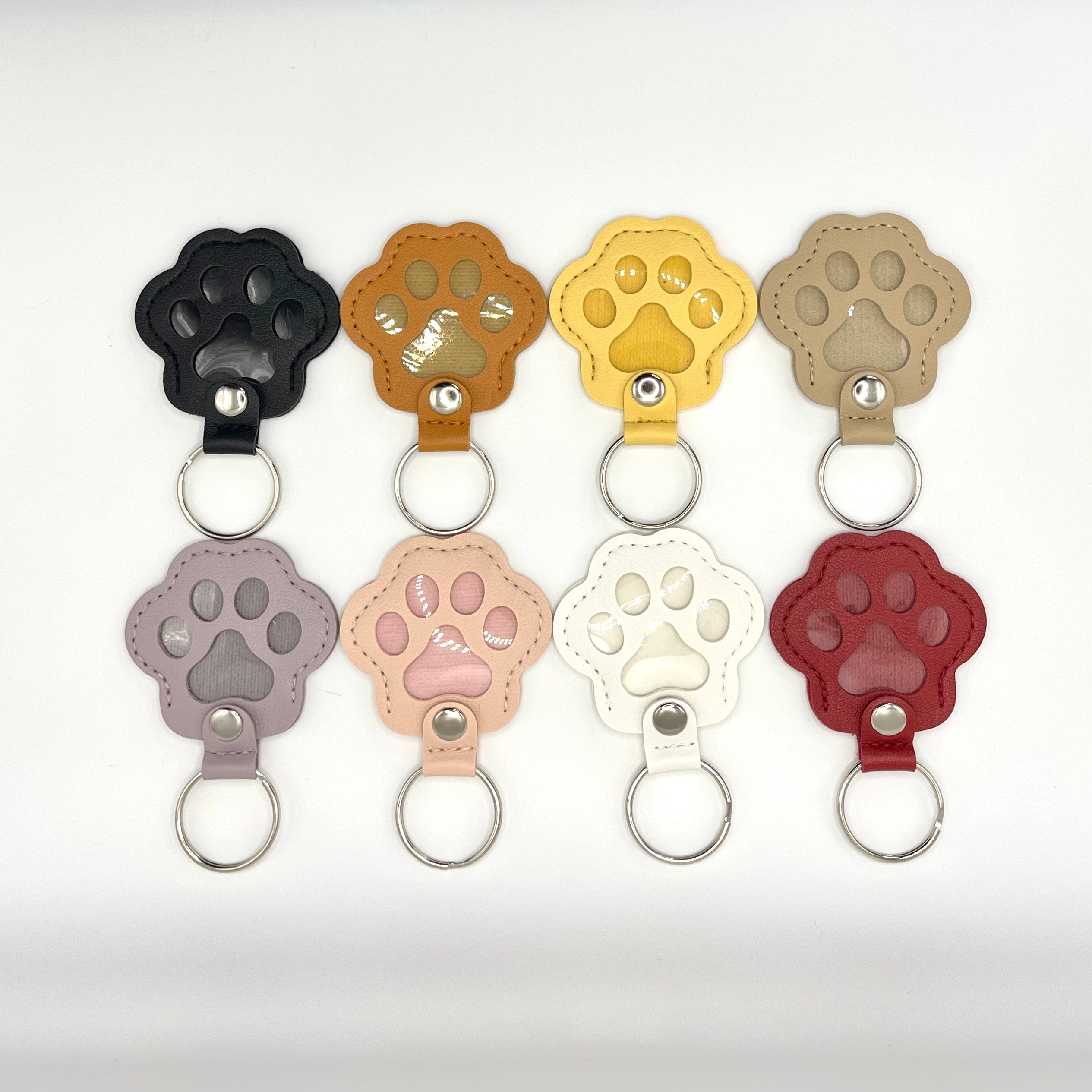 Faux leather paw keepsake keychains in eight colors with fur memory vial for cats and dogs.