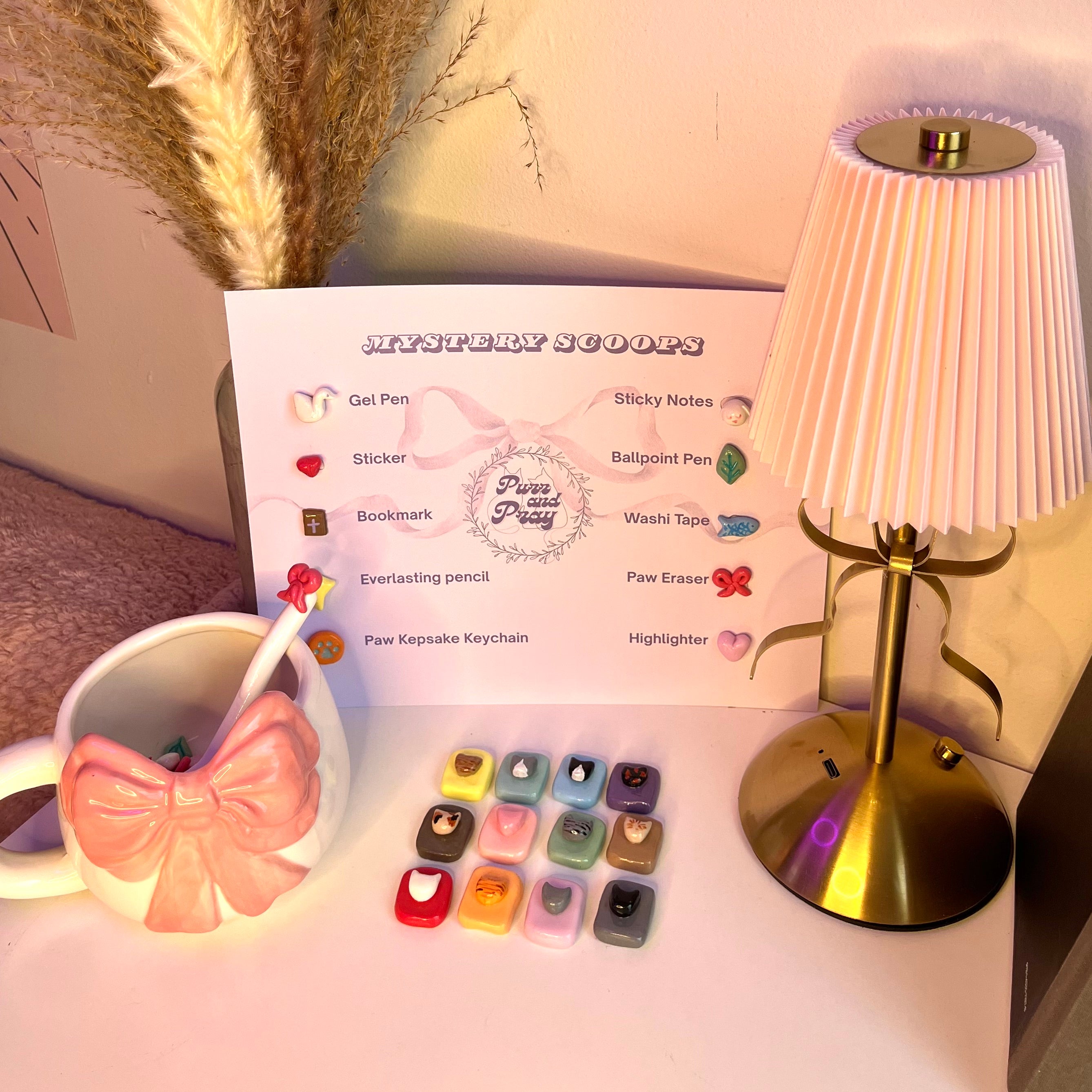 Desk setup with a lamp, mug, and stationery items on a desk.