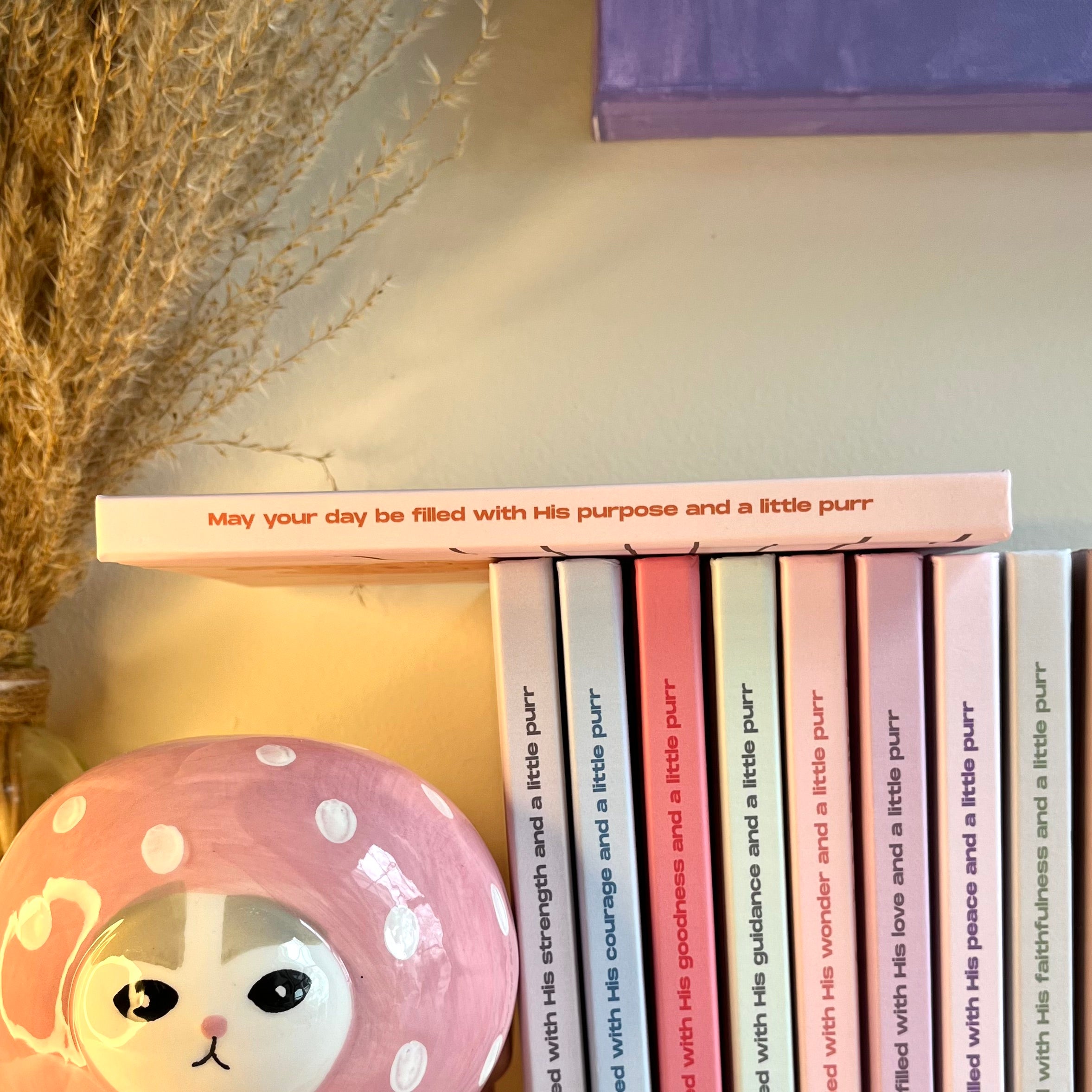 Side of an orange notebook with a christian text on it.