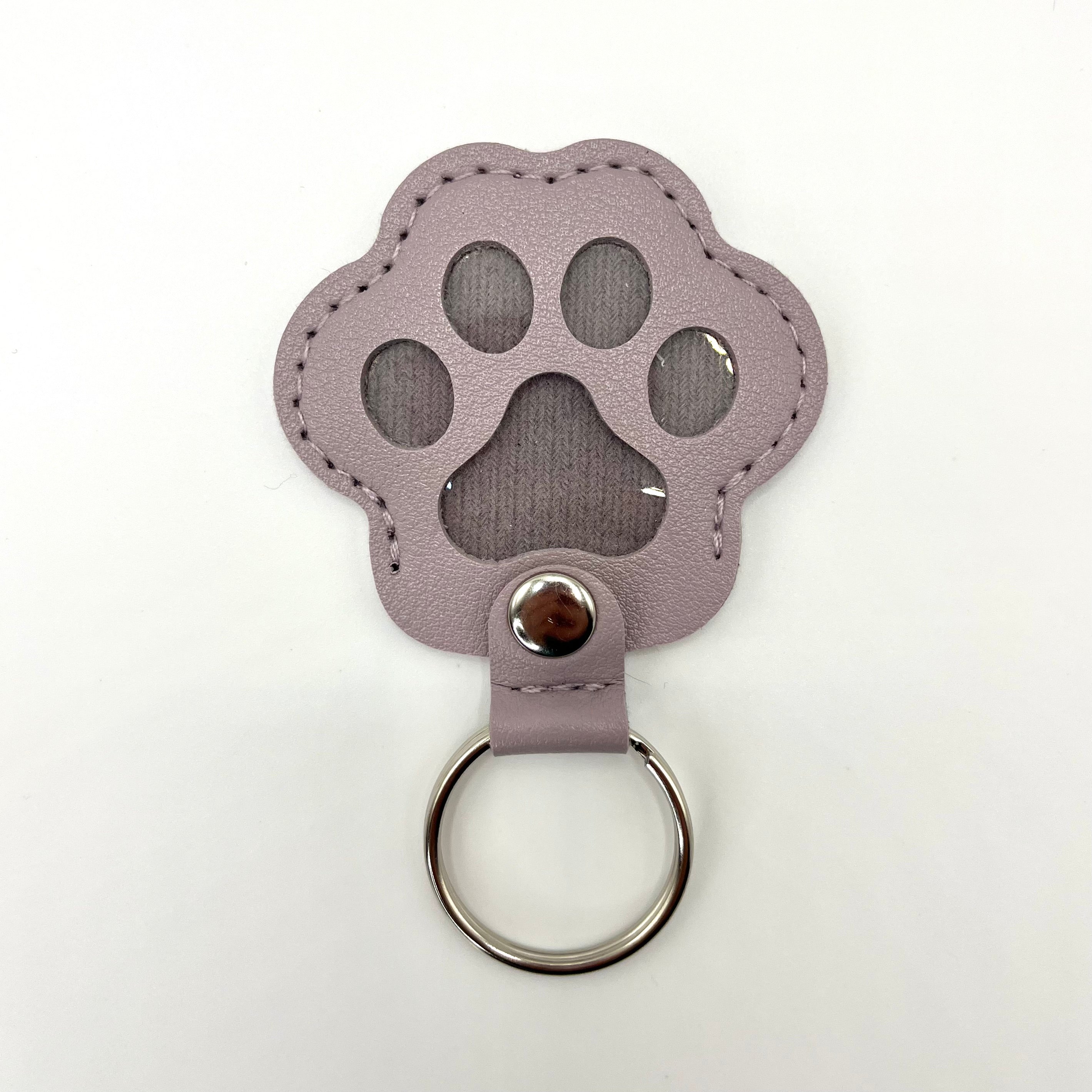 Purple faux leather paw-shaped keepsake keychain with metal ring – pet memorial gift.