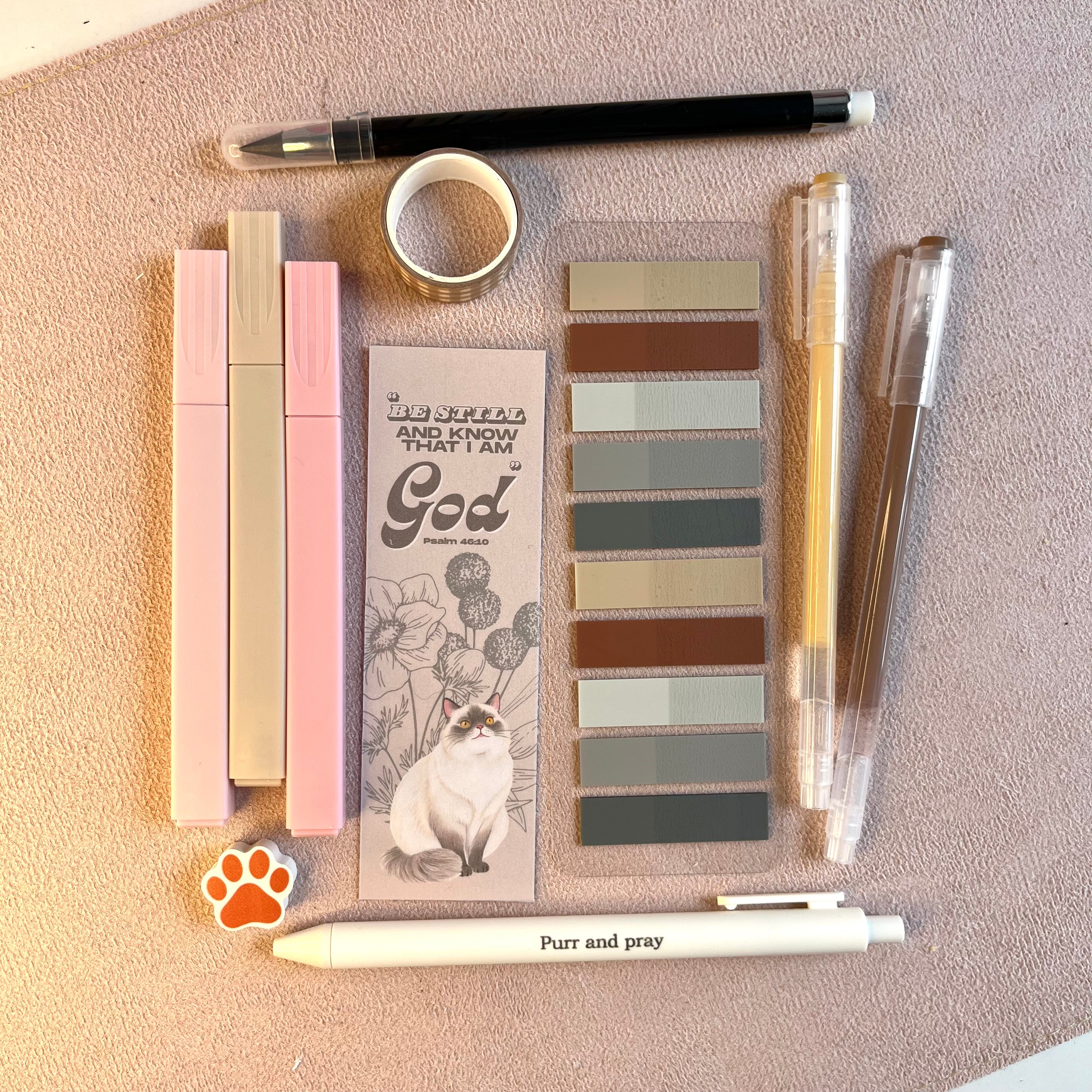 Collection of beige stationery products including on a textured surface.