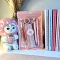 Set of light pink stationery items in a clear plastic bag.