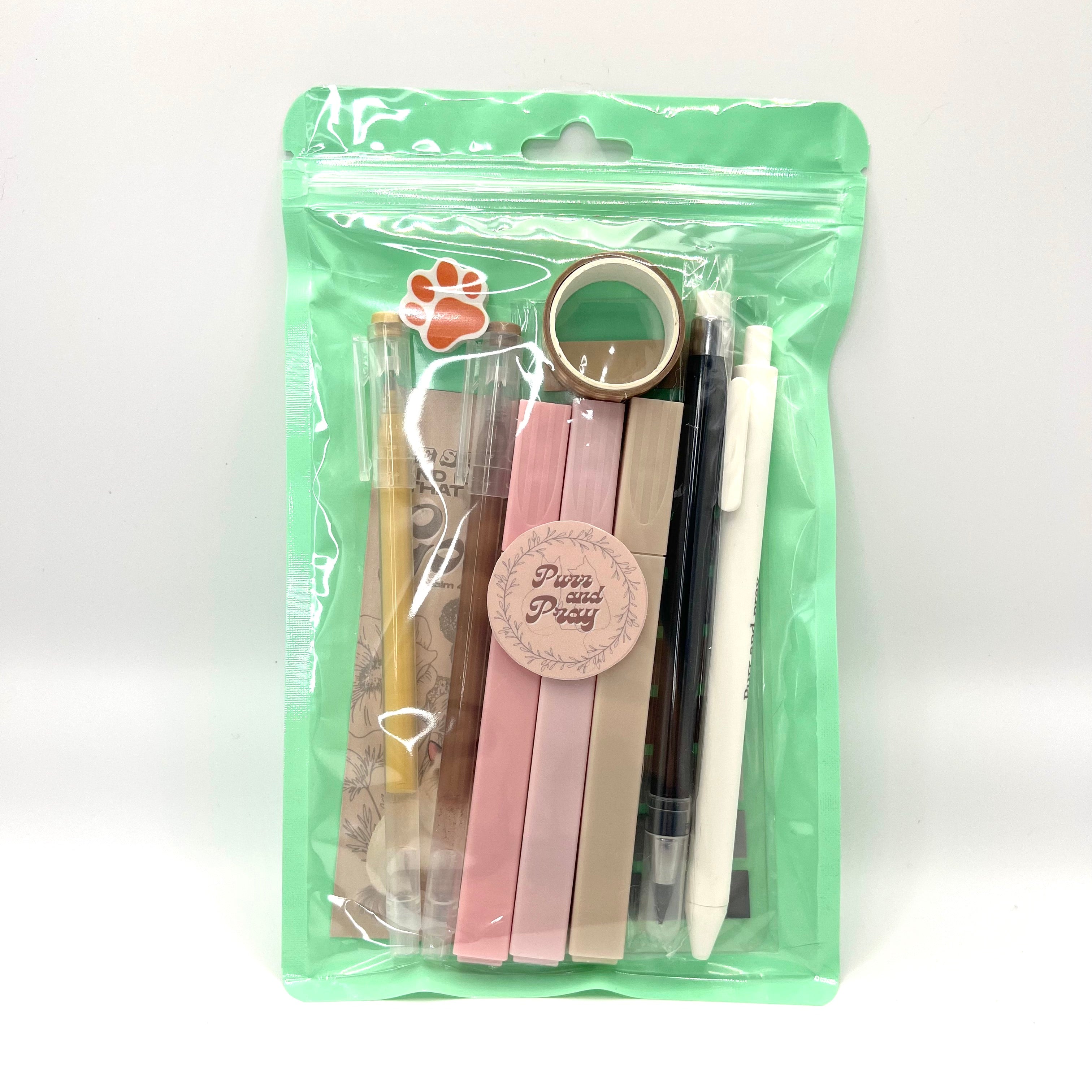 Stationery set packaged in a clear bag including pens, highlighters, sticky notes, washi tape, bookmark, and eraser for Christian journaling arranged neatly in beige color palette.