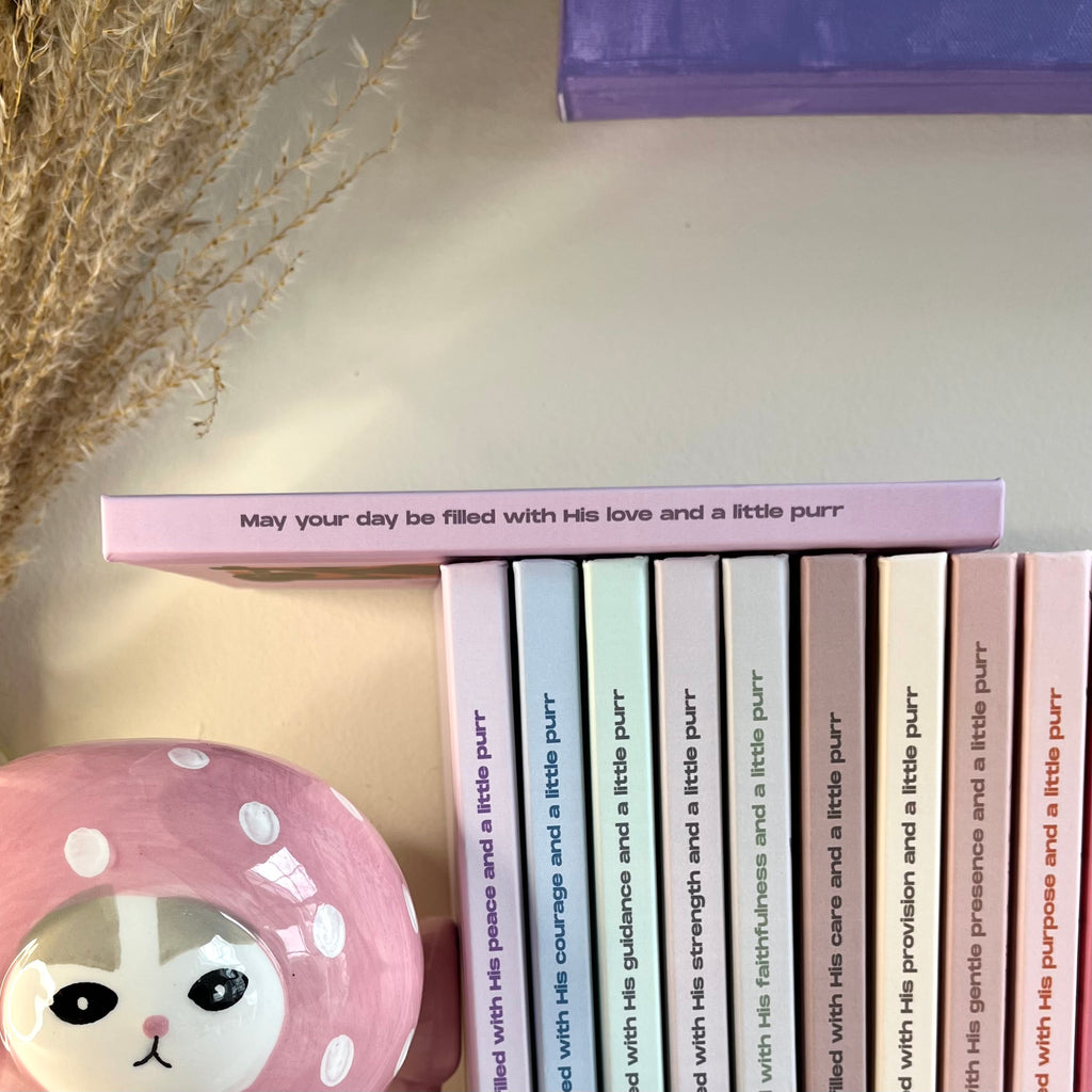 Side of a purple notebook with a christian text on it.