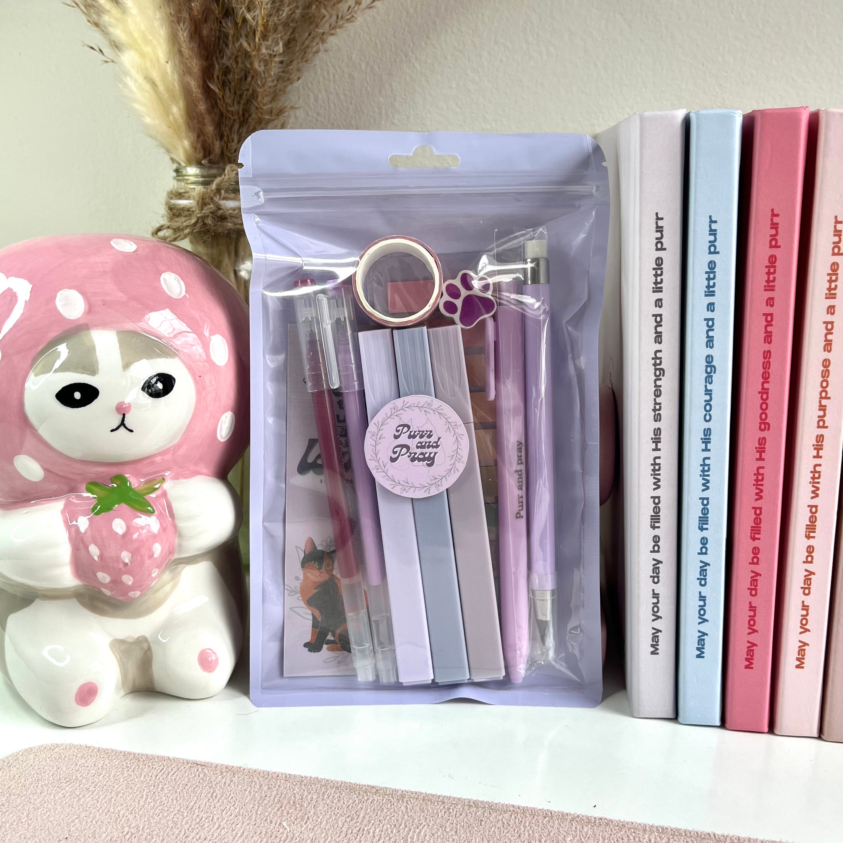 Packaged purple stationery set with tortie cat illustration.