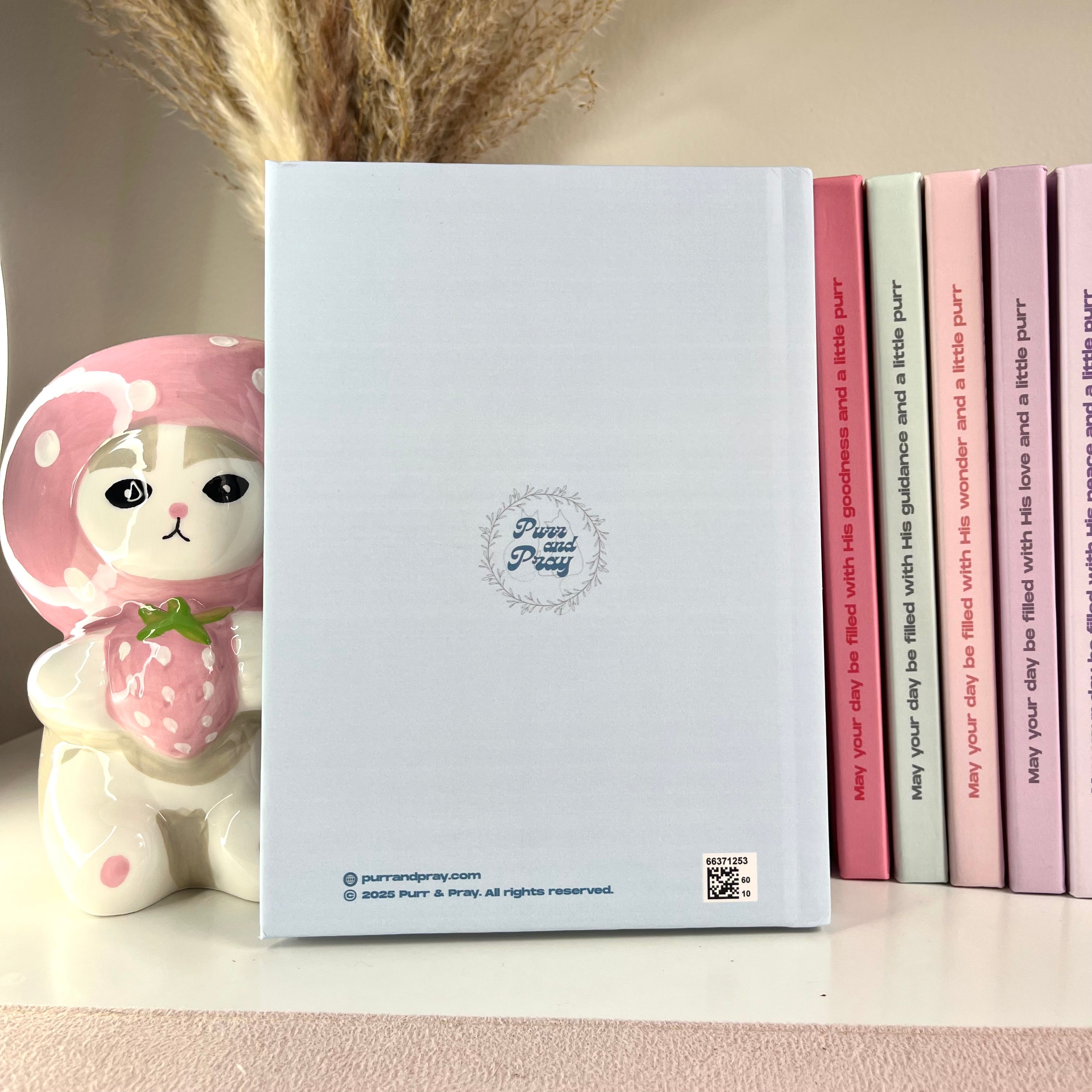 Blue notebook with a cute character design on a shelf