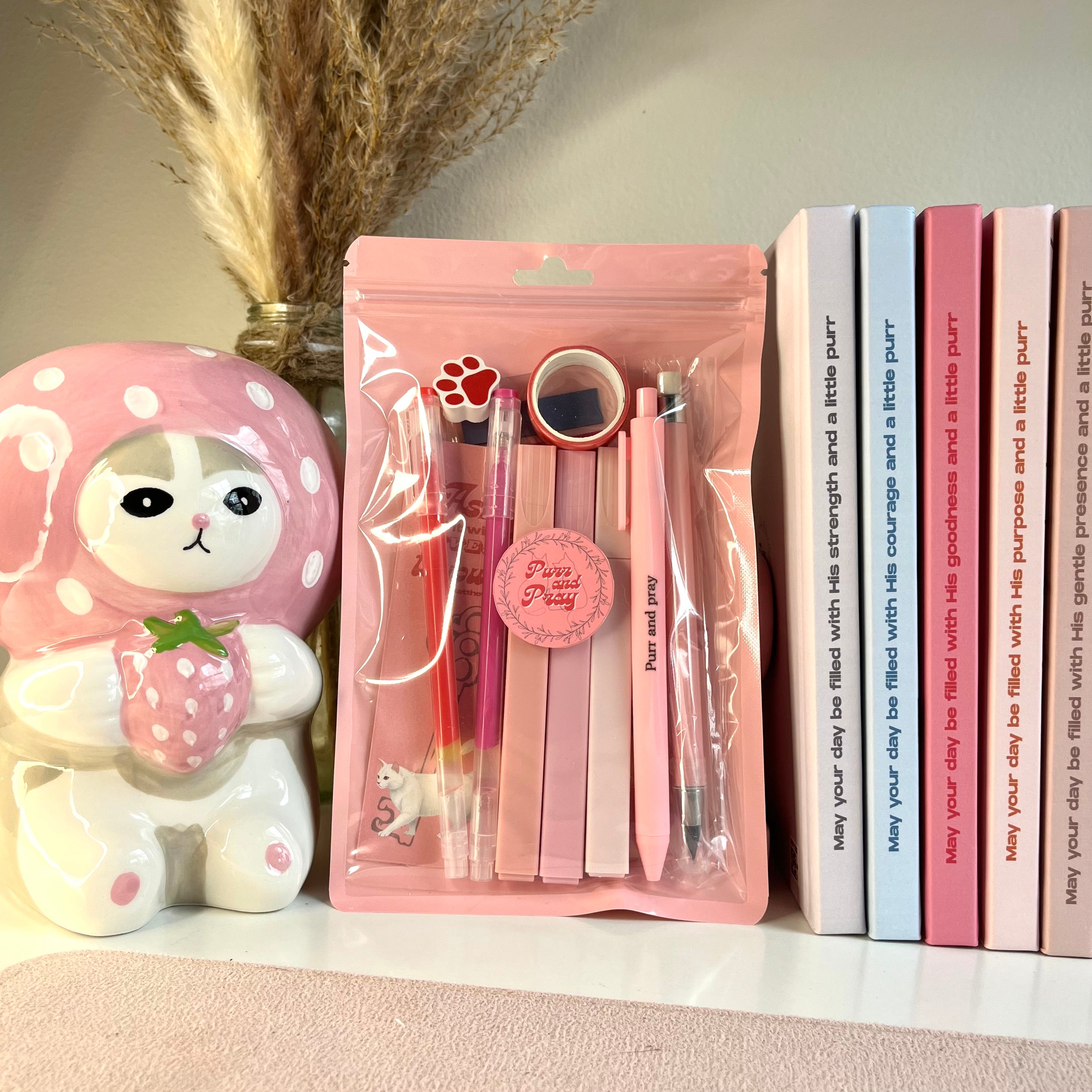 Pink stationery set in a plastic bag with white cat illustartion.